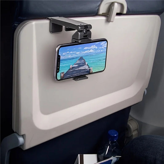 Phone holder being used to clip on to the tray table on an airplane