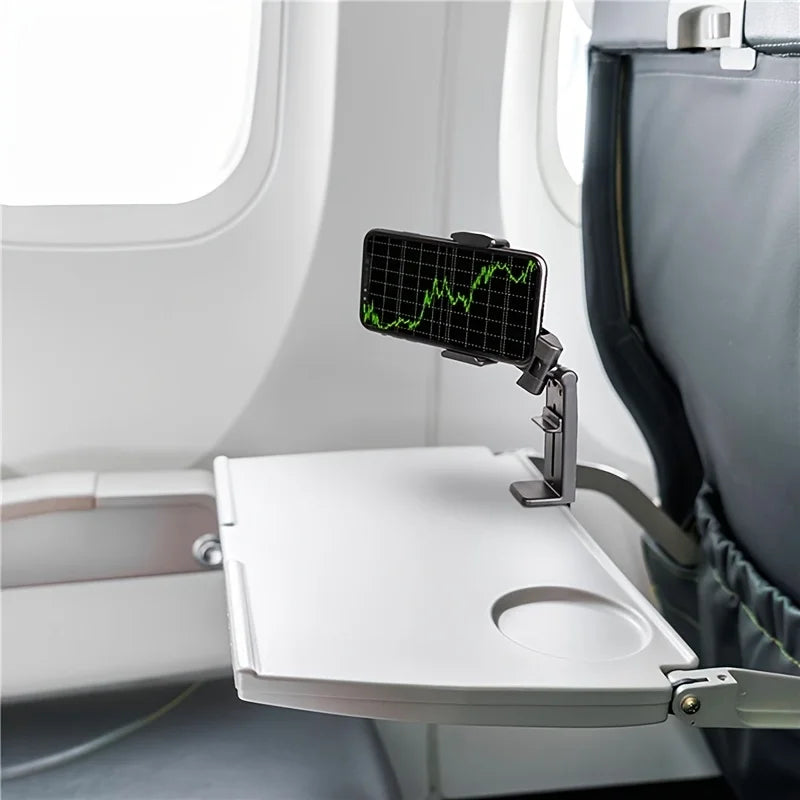 Phone holder being used to clip on to the tray table on an airplane