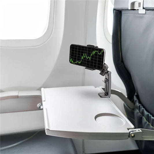 Phone holder being used to clip on to the tray table on an airplane